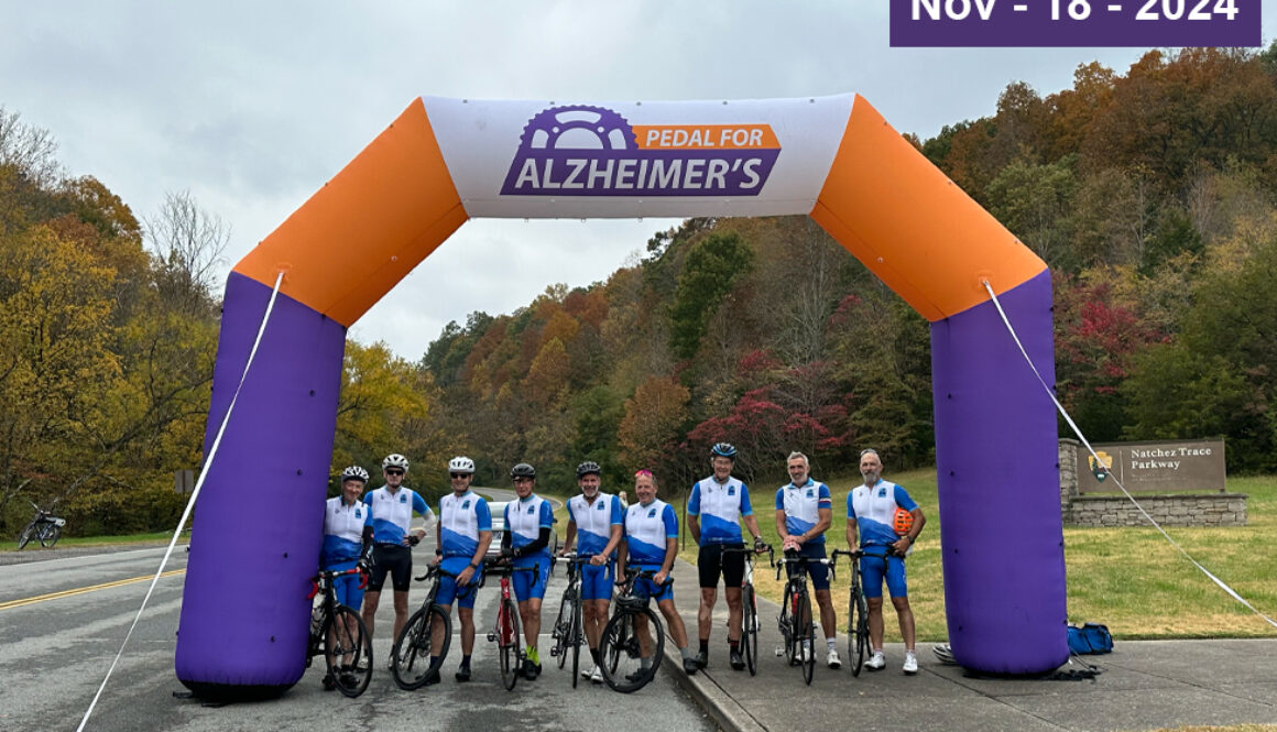 Pedal for Alzheimer's cyclists gather for a picture at the entrance to Natchez Chase Parkway